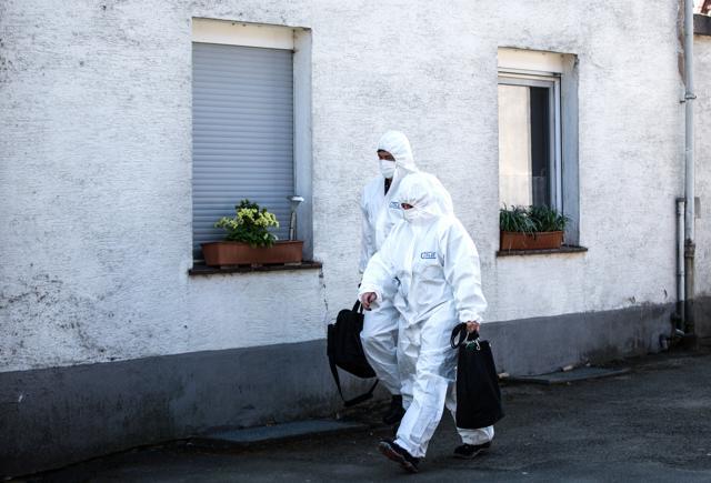 In this May 2, 2016 photo police officers in protective suits pass by a house outside Hoexter, western Germany. (AP) In this May 2, 2016 photo police officers in protective suits pass by a house outside Hoexter, western Germany. (AP)