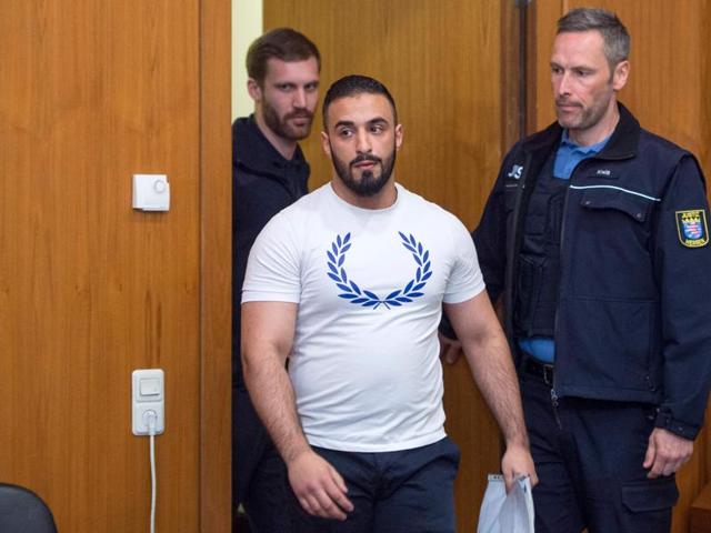 21-year-old German jihadist Aria Ladjedvardi (C) went on trial Tuesday for war crimes in Syria after allegedly posing for photographs next to the severed heads of two victims of the conflict. (AFP Photo) 21-year-old German jihadist Aria Ladjedvardi (C) went on trial Tuesday for war crimes in Syria after allegedly posing for photographs next to the severed heads of two victims of the conflict. (AFP Photo)