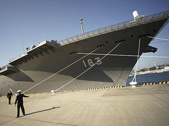 Defence personnel prepare to receive Union defence minister Manohar Parrikar in front of the latest destroyer Izumo of Japan's Maritime Self-Defence Force (JMSDF) in Yokosuka, south of Tokyo. (AP) Defence personnel prepare to receive Union defence minister Manohar Parrikar in front of the latest destroyer Izumo of Japan's Maritime Self-Defence Force (JMSDF) in Yokosuka, south of Tokyo. (AP)