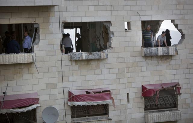 Palestinians inspect the damaged house of Zaid Amer, after it was demolished by the Israeli army, in the West Bank city of Nablus, Tuesday, May 3, 2016. (AP)