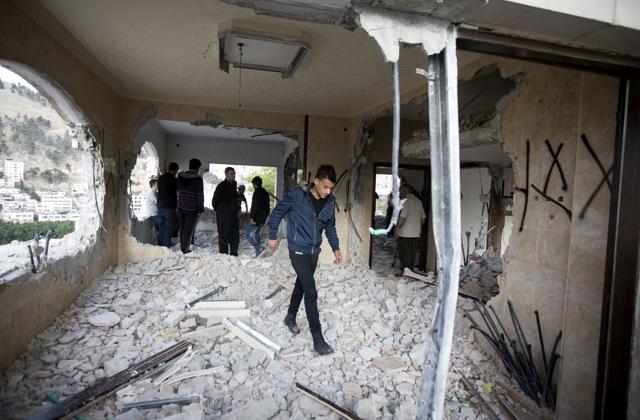 Palestinians inspect the damaged house of Zaid Amer, after it was demolished by the Israeli army, in the West Bank city of Nablus, Tuesday, May 3, 2016. (AP)