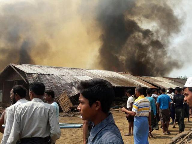 The charred remains of wooden shelters and twisted metal roofs were visible through a thick haze of smoke after the fire broke out. (AP Photo) The charred remains of wooden shelters and twisted metal roofs were visible through a thick haze of smoke after the fire broke out. (AP Photo)
