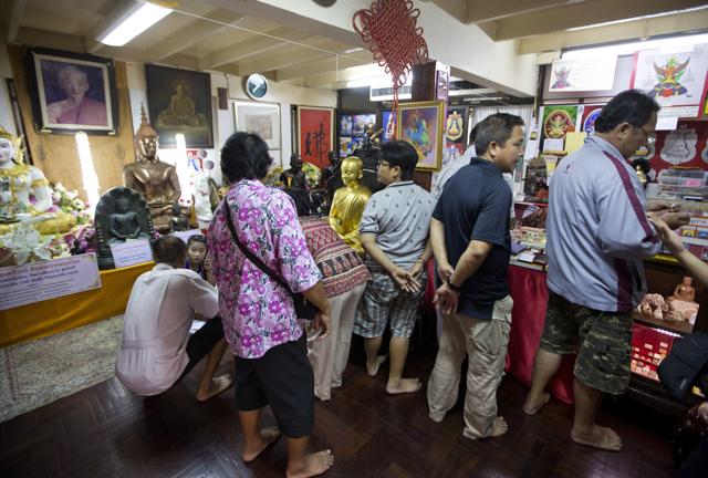Visitors look for items to buy in a shop at the Wat Traimitr Withayaram temple in Bangkok. (AP) Visitors look for items to buy in a shop at the Wat Traimitr Withayaram temple in Bangkok. (AP)