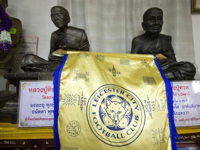 Visitors walk around the Wat Traimitr Withayaram temple in Bangkok, Thailand. The Buddhist temple has turned overnight into a venerated site for Leicester City's fans, at least in Thailand. (AP) Visitors walk around the Wat Traimitr Withayaram temple in Bangkok, Thailand. The Buddhist temple has turned overnight into a venerated site for Leicester City's fans, at least in Thailand. (AP)