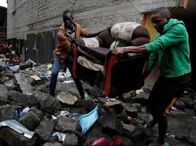 People carry a sofa as they leave the Huruma neighbourhood during the search for residents feared trapped in the rubble of a six-storey building that collapsed after days of heavy rain, in Nairobi. (Reuters) People carry a sofa as they leave the Huruma neighbourhood during the search for residents feared trapped in the rubble of a six-storey building that collapsed after days of heavy rain, in Nairobi. (Reuters)