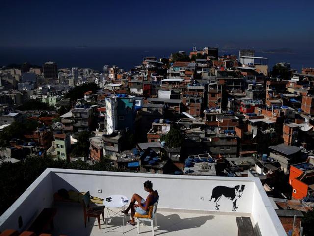 Hostels in a few of Rio’s more than 1,000 slums will serve as a cheap housing alternative for the more adventurous among the estimated 500,000 foreign tourists expected to arrive for the Olympics in August. A woman sits on a terrace at Tiki hostel in Cantagalo favela in Rio de Janeiro, Brazil, April 16, 2016. (REUTERS) 