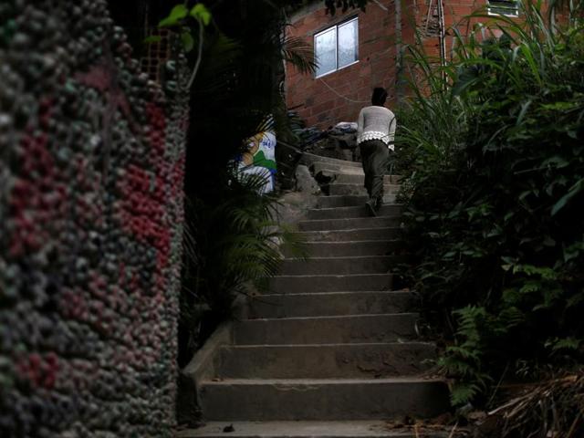 Favelas are slums in Brazil, which first appeared in the late 19th century and were built by Brazilian soldiers who had nowhere to live. Solange, a worker in the city’s Pousada Favelinha hostel, returns to the hostel.  (REUTERS) 