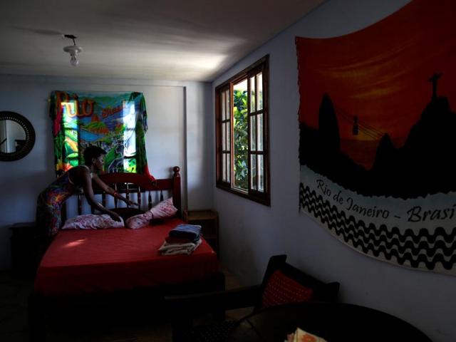 A worker at Pousada Favelinha hostel prepares a room. (REUTERS) 
