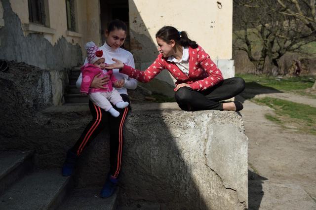 Lorena holds her child as she speaks with a friend at her home in an abandoned building. (AFP) Lorena holds her child as she speaks with a friend at her home in an abandoned building. (AFP)