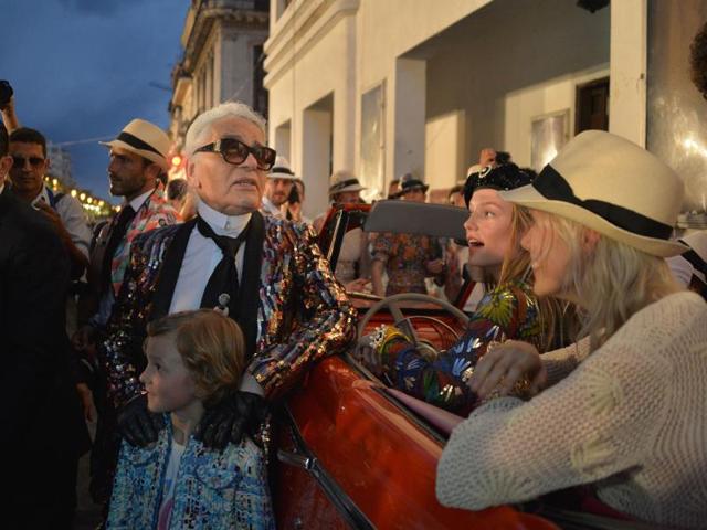 Karl Lagerfeld poses for pictures with his godson Hudson, the son of model Brad Kroenig who has long collaborated with the designer. (AFP) Karl Lagerfeld poses for pictures with his godson Hudson, the son of model Brad Kroenig who has long collaborated with the designer. (AFP)