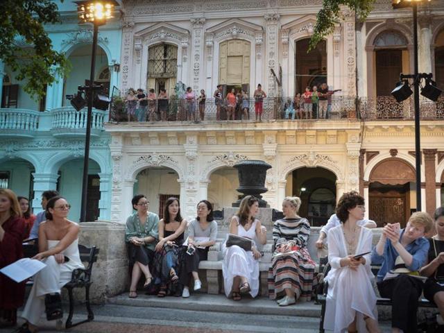 From their houses (at back) Cubans try to watch the Chanel performance at the Prado promenade in Havana. (AFP) From their houses (at back) Cubans try to watch the Chanel performance at the Prado promenade in Havana. (AFP)