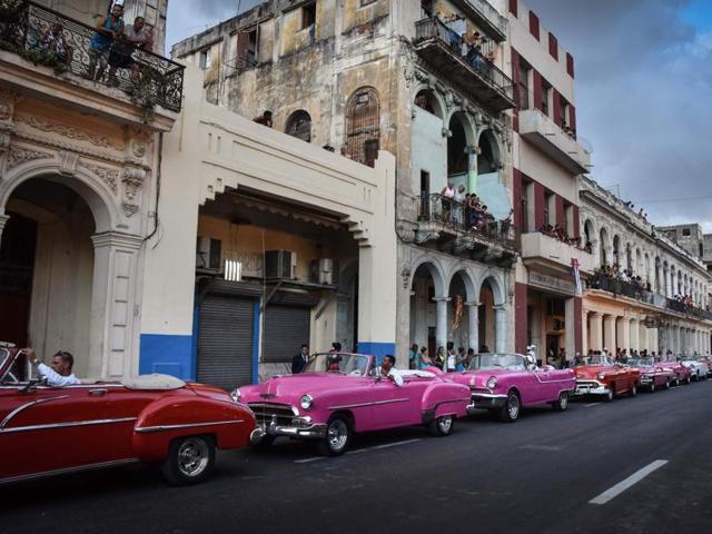 Cubans without an invitation to the exclusive event meanwhile packed the balconies of old Havana or lined the police cordon outside, straining to catch a glimpse of the beauties in the distance. (AFP) Cubans without an invitation to the exclusive event meanwhile packed the balconies of old Havana or lined the police cordon outside, straining to catch a glimpse of the beauties in the distance. (AFP)