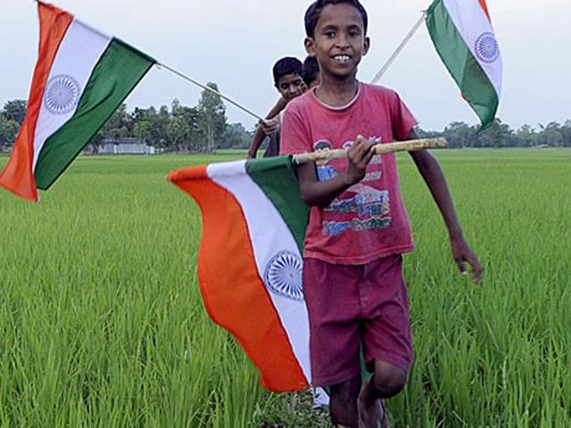 Children wave the Indian flag to celebrate the exchange of enclaves between India and Bangladesh. (Subhendu Ghosh/HT File Photo) Children wave the Indian flag to celebrate the exchange of enclaves between India and Bangladesh. (Subhendu Ghosh/HT File Photo)