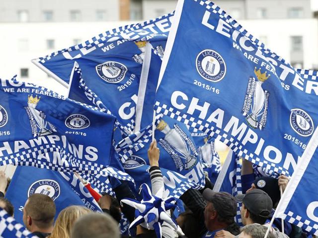 Leicester City fans celebrate with flags after they won their maiden English Premier League title, on Tuesday.(Reuters Photo)