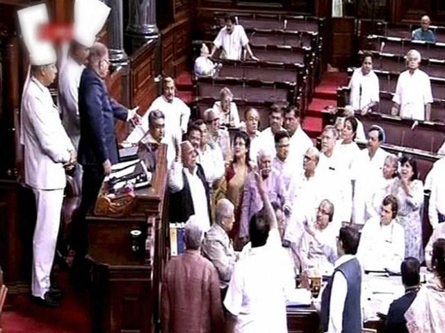 Members protest in the well of the Rajya Sabha in New Delhi on Monday. (PTI) Members protest in the well of the Rajya Sabha in New Delhi on Monday. (PTI)