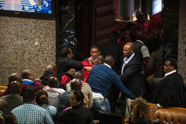 South African opposition party Economic Freedom Fighters MP Godrich Gardee (C, in red) is evicted with fellow EFF members during the South African president's budget speech at the South African parliament in Cape Town on May 4, 2016 (AFP) South African opposition party Economic Freedom Fighters MP Godrich Gardee (C, in red) is evicted with fellow EFF members during the South African president's budget speech at the South African parliament in Cape Town on May 4, 2016 (AFP)