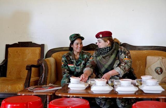 Haseba Nauzad (right) and Yazidi female fighter Asema Dahir have lunch at a camp in Nawaran near Mosul in Iraq. (Reuters) Haseba Nauzad (right) and Yazidi female fighter Asema Dahir have lunch at a camp in Nawaran near Mosul in Iraq. (Reuters)