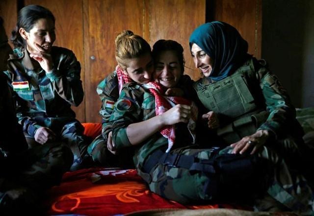 Asema Dahir shares a light moment with her comrades in a bedroom at their campsite in Nawaran. (Reuters) Asema Dahir shares a light moment with her comrades in a bedroom at their campsite in Nawaran. (Reuters)