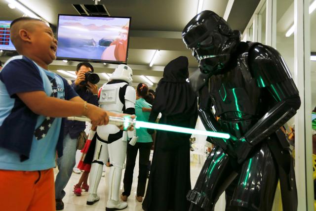 A member of a Star Wars fan club in Thailand, dressed as a Shadow stormtrooper plays with a boy during Star Wars Day celebration at the Queen Sirikit National Institute of Child Health in Bangkok, Thailand. (REUTERS) A member of a Star Wars fan club in Thailand, dressed as a Shadow stormtrooper plays with a boy during Star Wars Day celebration at the Queen Sirikit National Institute of Child Health in Bangkok, Thailand. (REUTERS)