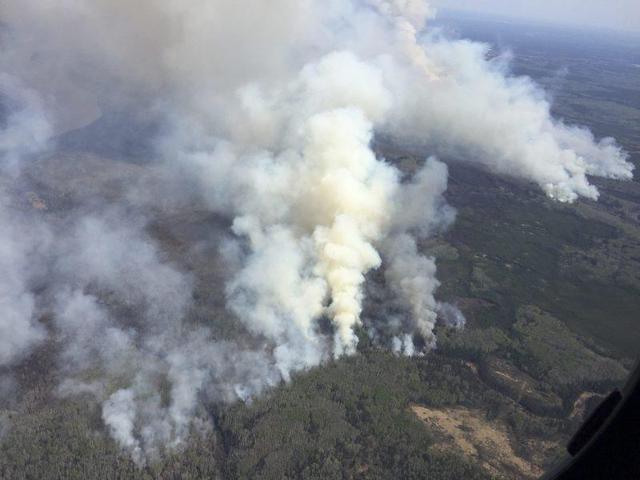 An aerial view from the helicopter of Alberta Premier Rachel Notley shows smoke rising from raging wildfires which caused the mandatory evacuation of Fort McMurray. (Reuters)