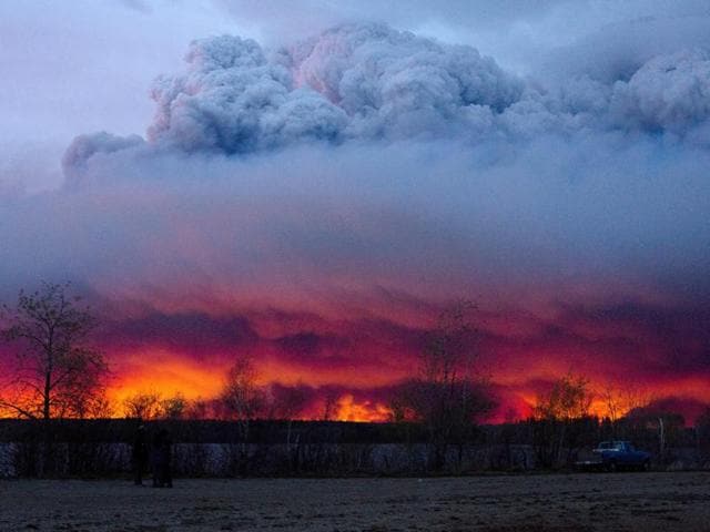 A wildfire moves towards the town of Anzac from Fort McMurray, Alberta, in western Canada. Alberta declared a state of emergency on Wednesday as crews frantically held back wind-whipped wildfires. Unseasonably hot temperatures combined with dry conditions have transformed the boreal forest in much of Alberta into a tinder box. (Jason Franson/The Canadian Press via AP)