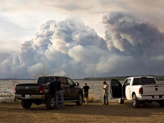 Evacuees watch the wildfire near Fort McMurray. (AP)