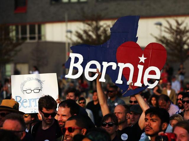 People cheer as Democratic presidential candidate Bernie Sanders walks on stage at a campaign rally in New York City. (AFP File Photo) People cheer as Democratic presidential candidate Bernie Sanders walks on stage at a campaign rally in New York City. (AFP File Photo)