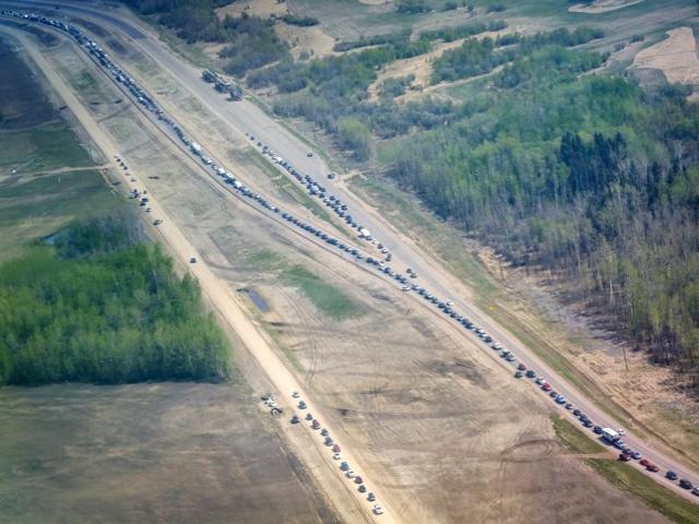 Traffic is at a standstill on Highway 63 heading south as residents flee with wildfires burning in and around Fort McMurray. (AP)