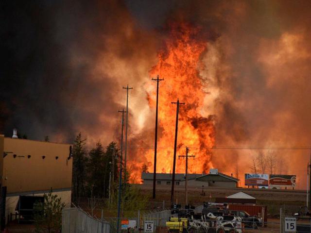 Flames rise in industrial area in south Fort McMurray. (REUTERS)