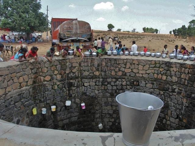 Villagers fetch water from a well filled by a tanker in Thakrechi Wadi village at Shahapur Taluka in Thane district.(Praful Gangurde)