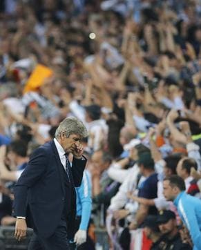 Manchester City's manager Manuel Pellegrini walks away after Real Madrid's Gareth Bale scored the opening goal during the Champions League semifinal match at the Santiago Bernabeu stadium in Madrid. (AP Photo)