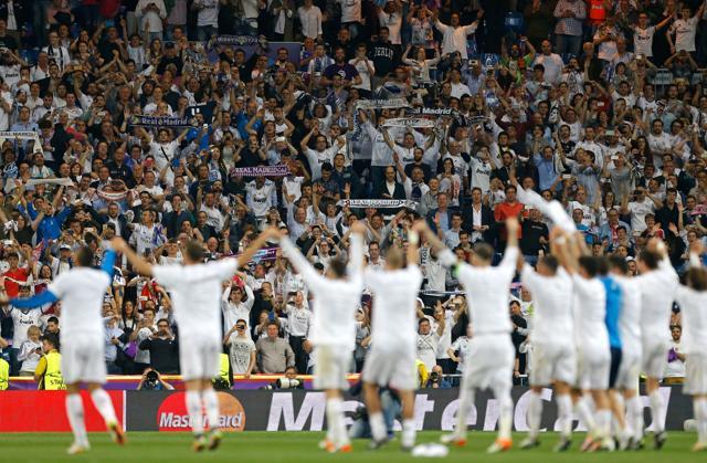 Real Madrid players celebrate with their supporters at the end of the Champions League semifinal. (AP Photo)