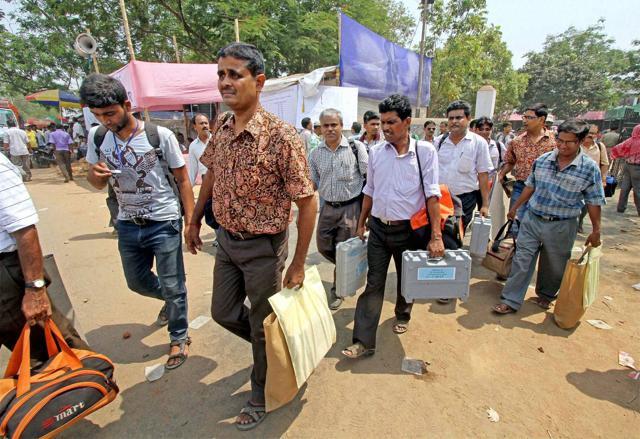 Poll officials carry electronic voting machines as they leave for their respective polling booths at Bolpur in Birbhum district of West Bengal. (PTI file photo) Poll officials carry electronic voting machines as they leave for their respective polling booths at Bolpur in Birbhum district of West Bengal. (PTI file photo)