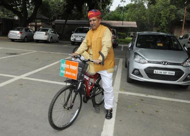 Arjun Ram Meghwal with his cycle after attending the first day of the Monsoon session on Tuesday. (HT File Photo) Arjun Ram Meghwal with his cycle after attending the first day of the Monsoon session on Tuesday. (HT File Photo)