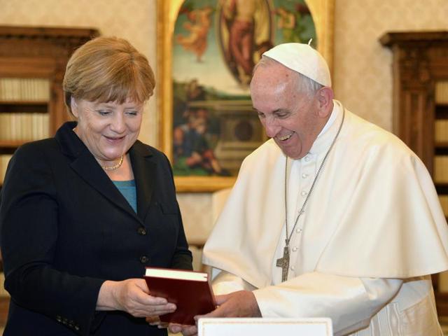 German Chancellor Angela Merkel (left) shakes hands with Pope Francis during a private audience at the Vatican on Friday. Merkel is in Rome to take part in a ceremony for awarding Germany's famed Charlemagne Prize to the pope. (AFP) German Chancellor Angela Merkel (left) shakes hands with Pope Francis during a private audience at the Vatican on Friday. Merkel is in Rome to take part in a ceremony for awarding Germany's famed Charlemagne Prize to the pope. (AFP)