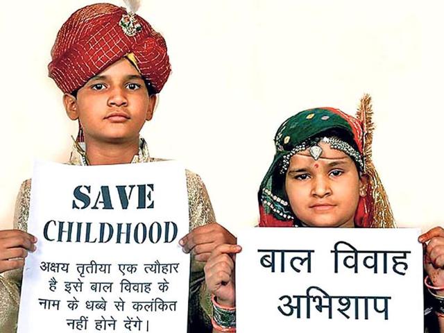 Children hold placards with anti-child marriage slogans.(Pic for representation) Children hold placards with anti-child marriage slogans.(Pic for representation)