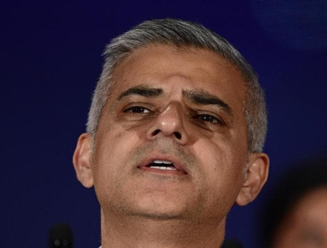 London's new Mayor Sadiq Khan (R) addresses the media as Paul Golding (Far L) the candidate for Britain First, turns his back during the address at City Hall in central London . (AFP) London's new Mayor Sadiq Khan (R) addresses the media as Paul Golding (Far L) the candidate for Britain First, turns his back during the address at City Hall in central London . (AFP)
