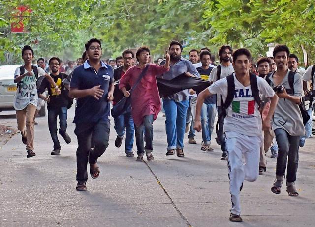 Jadavpur University Students chasing the car of film director Vivek Agnihotri to show him black flag as they protest against screening of his new film ‘Buddha in a Traffic Jam’ at University campus in Kolkata on Friday. (PTI) Jadavpur University Students chasing the car of film director Vivek Agnihotri to show him black flag as they protest against screening of his new film ‘Buddha in a Traffic Jam’ at University campus in Kolkata on Friday. (PTI)
