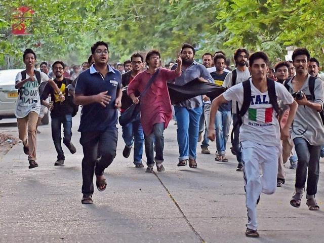 Jadavpur University Students chasing the car of film director Vivek Agnihotri to show him black flag as they protest against screening of his new film 'Buddha in a Traffic Jam' at University campus in Kolkata on May 6. (PTI) Jadavpur University Students chasing the car of film director Vivek Agnihotri to show him black flag as they protest against screening of his new film 'Buddha in a Traffic Jam' at University campus in Kolkata on May 6. (PTI)