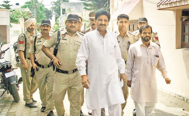 Shiv Sena (Bal Thackeray) Punjab chief Yograj Sharma with his security guards in Pathankot. (Keshav Singh/HT Photo) Shiv Sena (Bal Thackeray) Punjab chief Yograj Sharma with his security guards in Pathankot. (Keshav Singh/HT Photo)