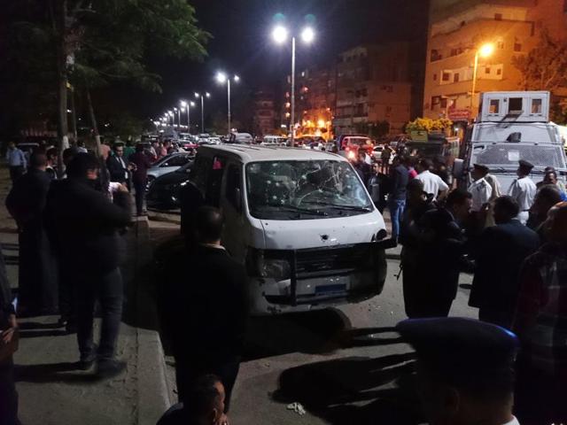 Egyptian police and civilians gather around a bullet-ridden microbus in the south Cairo neighborhood of Helwan on Sunday. (AP) Egyptian police and civilians gather around a bullet-ridden microbus in the south Cairo neighborhood of Helwan on Sunday. (AP)