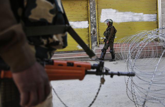 Indian paramilitary soldiers stand guard near a barbed wire set up as a barricade in Kashmir. (AP file photo) Indian paramilitary soldiers stand guard near a barbed wire set up as a barricade in Kashmir. (AP file photo)