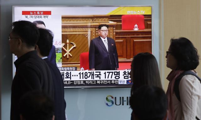 People walk by a TV screen showing North Korean leader Kim Jong Un during the 7th Congress of the Workers' Party of Korea on Friday, at the Seoul Railway Station in Seoul, South Korea on Saturday. (AP) People walk by a TV screen showing North Korean leader Kim Jong Un during the 7th Congress of the Workers' Party of Korea on Friday, at the Seoul Railway Station in Seoul, South Korea on Saturday. (AP)