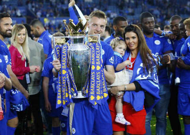 Leicester City's striker Jamie Vardy lifts the trophy as he celebrates winning the Barclays Premier League as partner Rebekah Nicholson looks on. (REUTERS) 