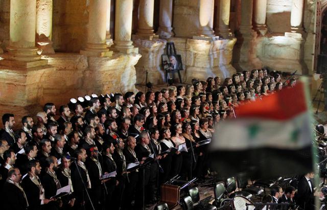 Al-Farah choir perform as a Syrian national flag flutters during the musical event. (REUTERS) Al-Farah choir perform as a Syrian national flag flutters during the musical event. (REUTERS)