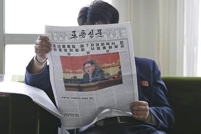 A North Korean man reads a local newspaper with an image of leader Kim Jong Un Sunday, May 8, 2016, in Pyongyang, North Korea. (AP)