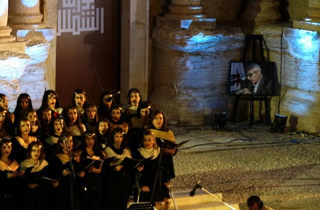 Singers perform next to a portrait of Khaled al-Assaad, the late 82-year old retired chief archaeologist of the ancient Syrian city of Palmyra. (AFP) Singers perform next to a portrait of Khaled al-Assaad, the late 82-year old retired chief archaeologist of the ancient Syrian city of Palmyra. (AFP)