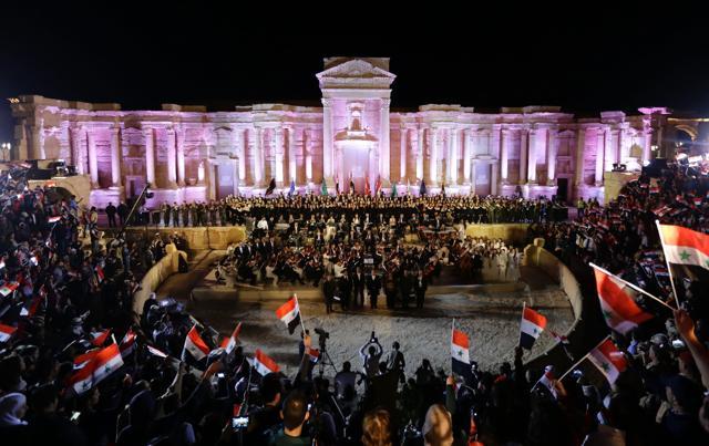 The audience waves Syrian flags as they attend the music concert. (AFP) The audience waves Syrian flags as they attend the music concert. (AFP)
