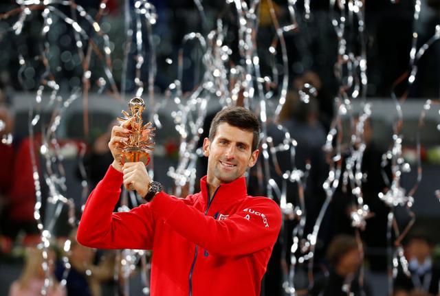 Djokovic holds up the trophy after defeating Murray. (Reuters Photo) Djokovic holds up the trophy after defeating Murray. (Reuters Photo)