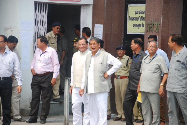 Former CM Harish Rawat with Congress MLA Yashpal Arya standing outside the assembly in Dehradun. (Vinay Santosh Kumar /HT Photo)